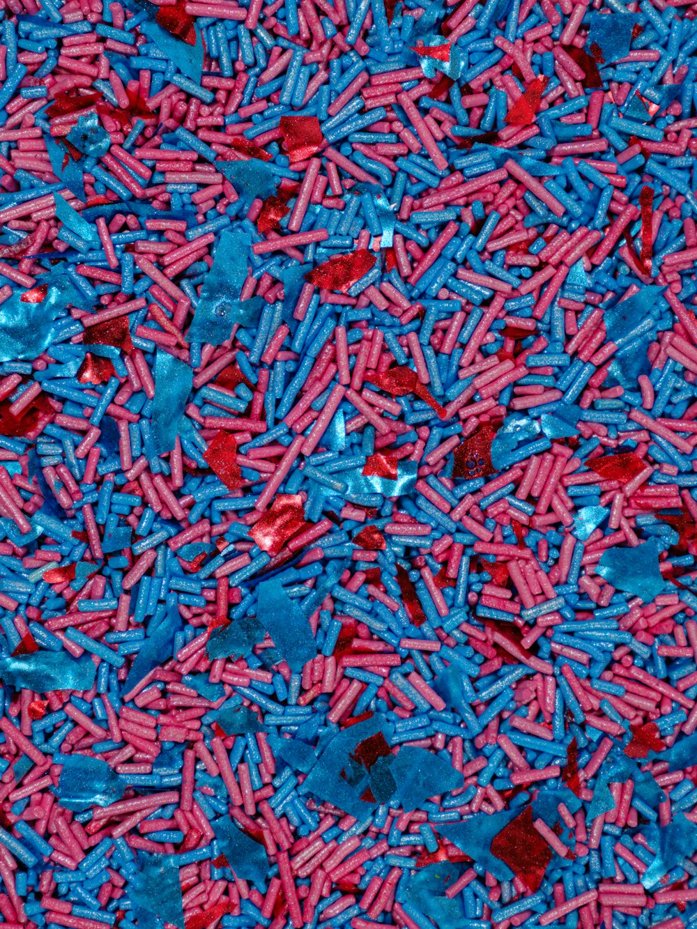 a pile of red and blue sprinkles sitting on top of a table