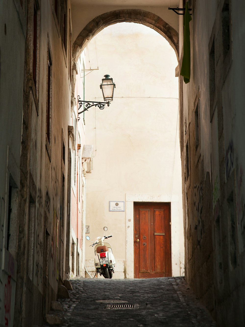 a motorcycle parked in an alley between two buildings