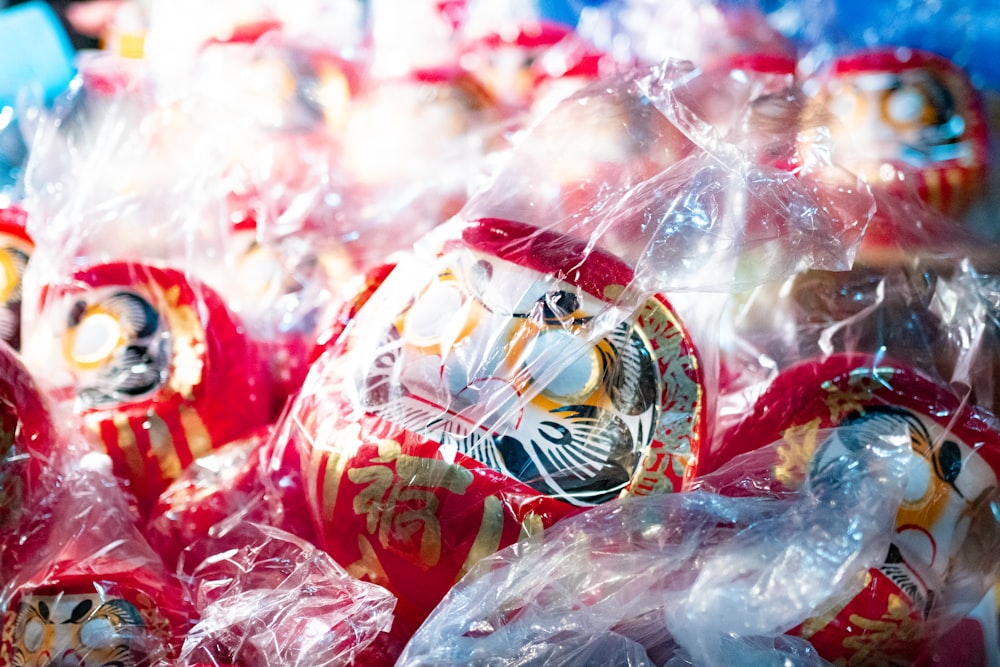 a pile of red and white christmas ornaments wrapped in plastic