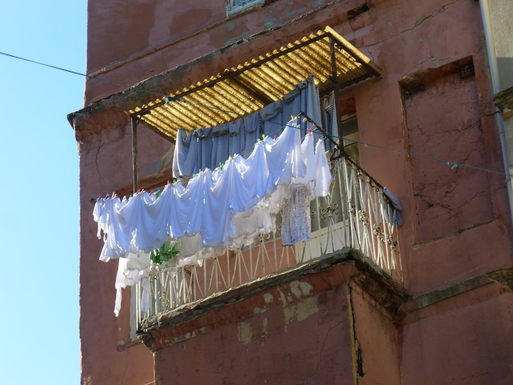 a balcony with clothes hanging out to dry