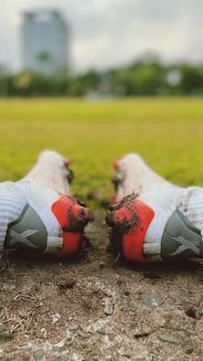 A close-up of cleats kicking up grass during a fast-paced match.
