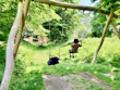 Kids playing with colorful outdoor toys in a sunny backyard.