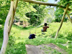 Kids playing with colorful outdoor toys in a sunny backyard.