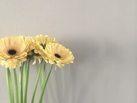 a bunch of yellow flowers in a vase