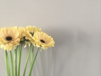 a bunch of yellow flowers in a vase