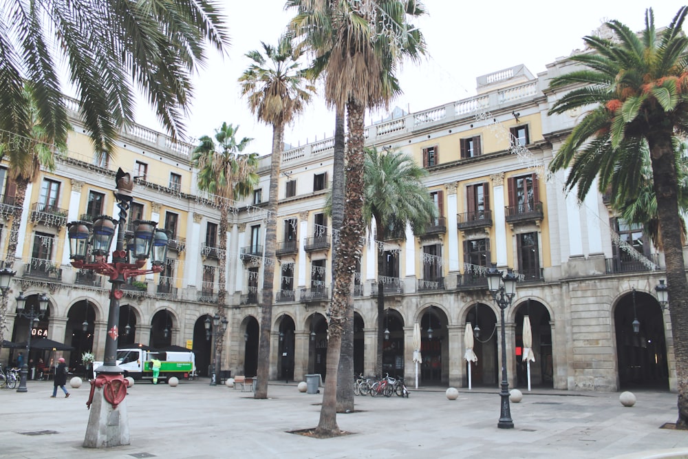 a large building with palm trees in front of it