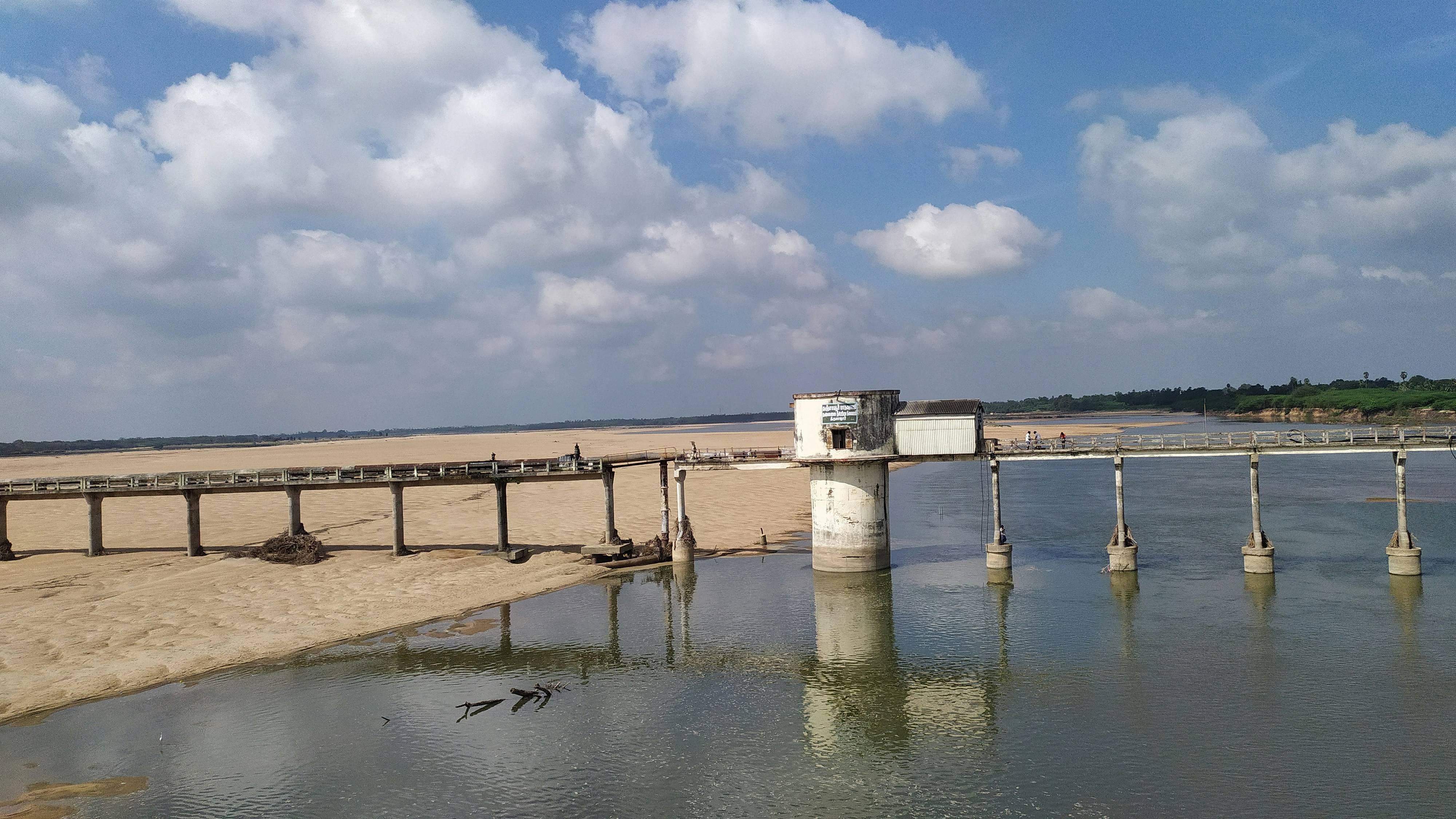 a bridge over a body of water on a beach
