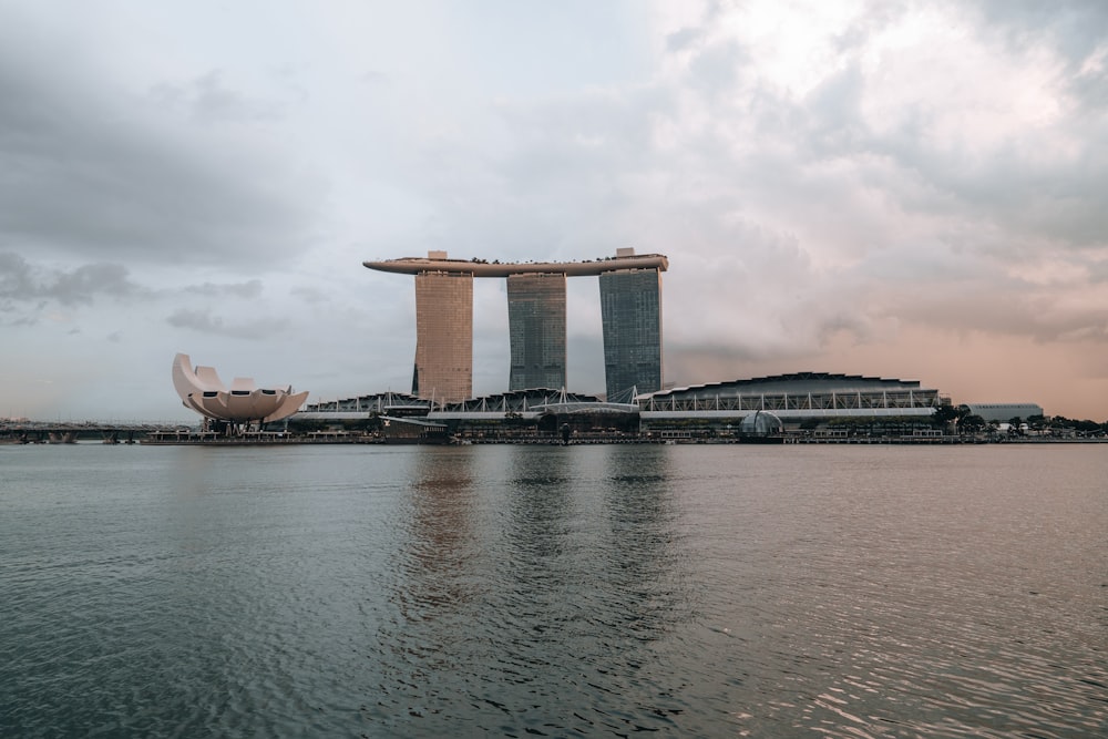 a large body of water next to a tall building