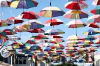 a bunch of colorful umbrellas hanging from the ceiling