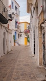 Charming narrow cobblestone street in a picturesque Albacete village with colorful houses.