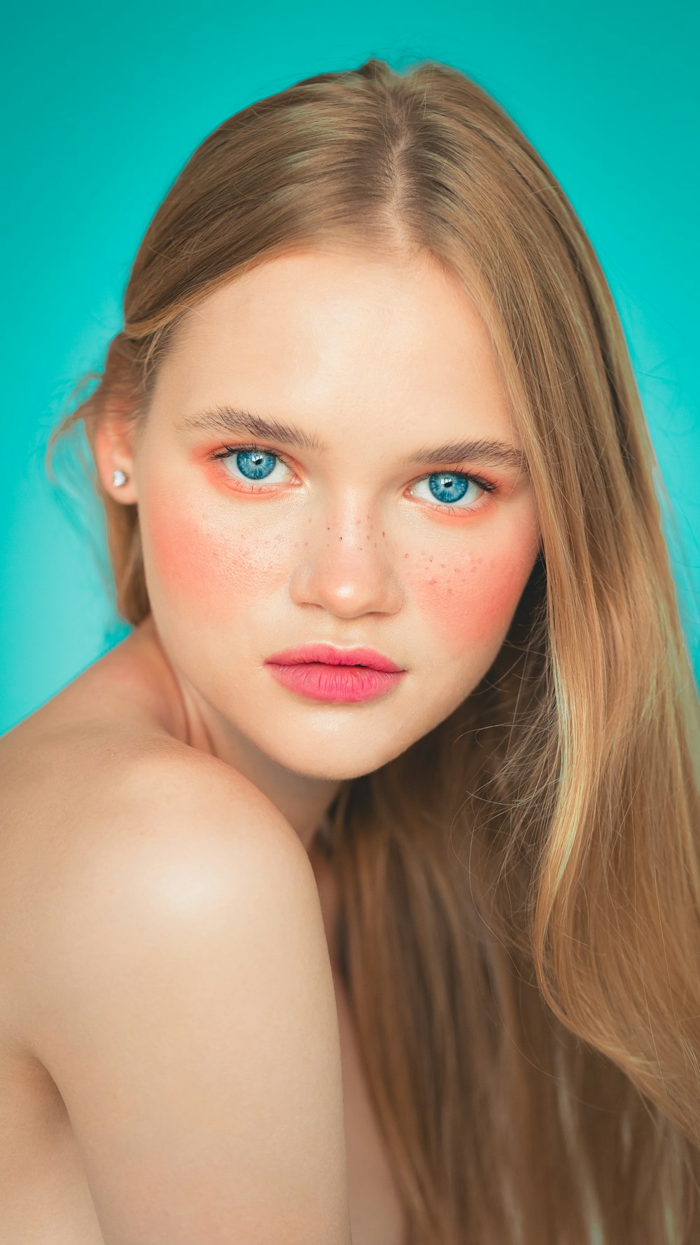 a woman with long hair and blue eyes