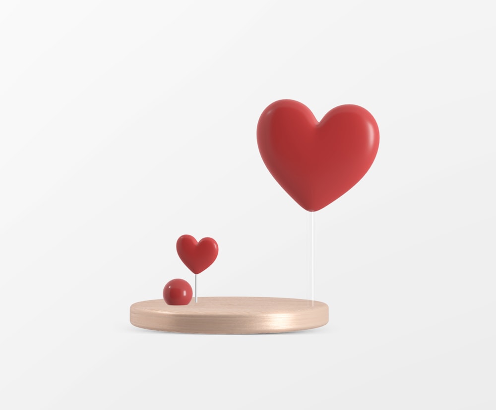 a heart shaped object on a wooden stand