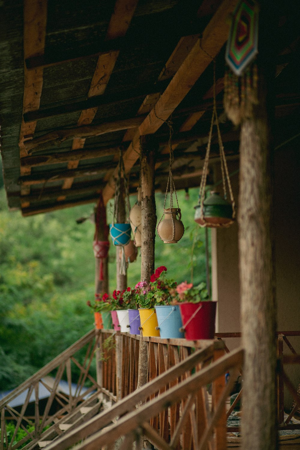 a porch with hanging planters filled with flowers
