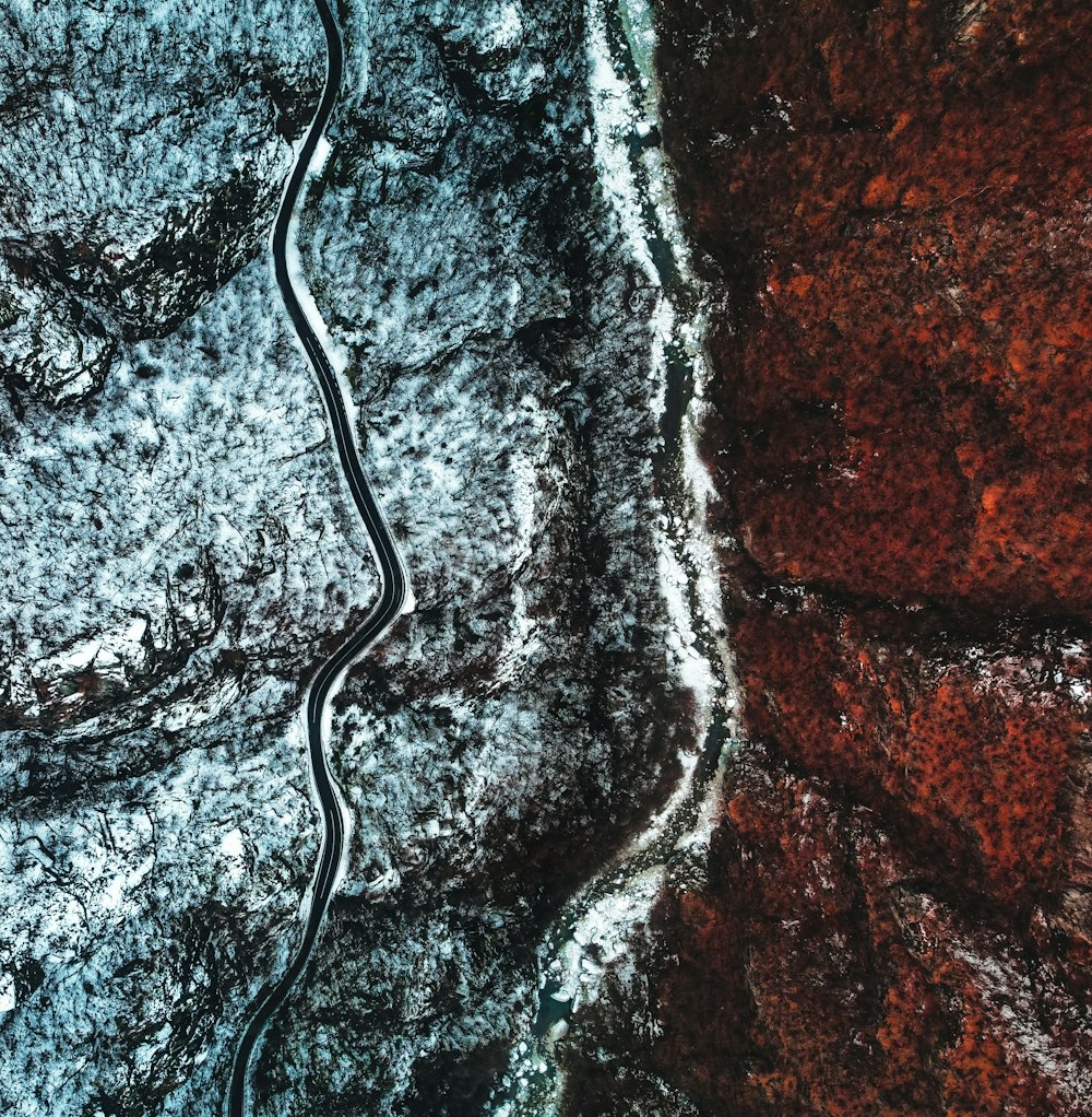 an aerial view of a winding road in the woods