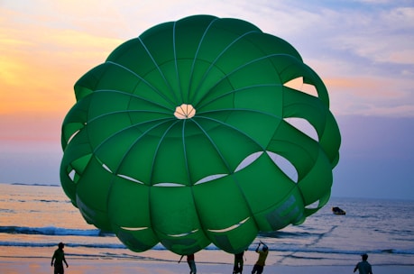 Close-up of hands gripping the vibrant fabric of a 5-meter parachute during a lively group game.