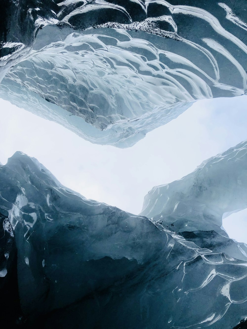 a large iceberg with snow on it's sides