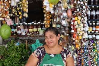 A mother smiling warmly while setting up her new small business stall.