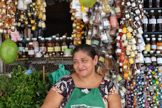 A warm, inviting photo of a smiling woman entrepreneur arranging beauty products on a display table.