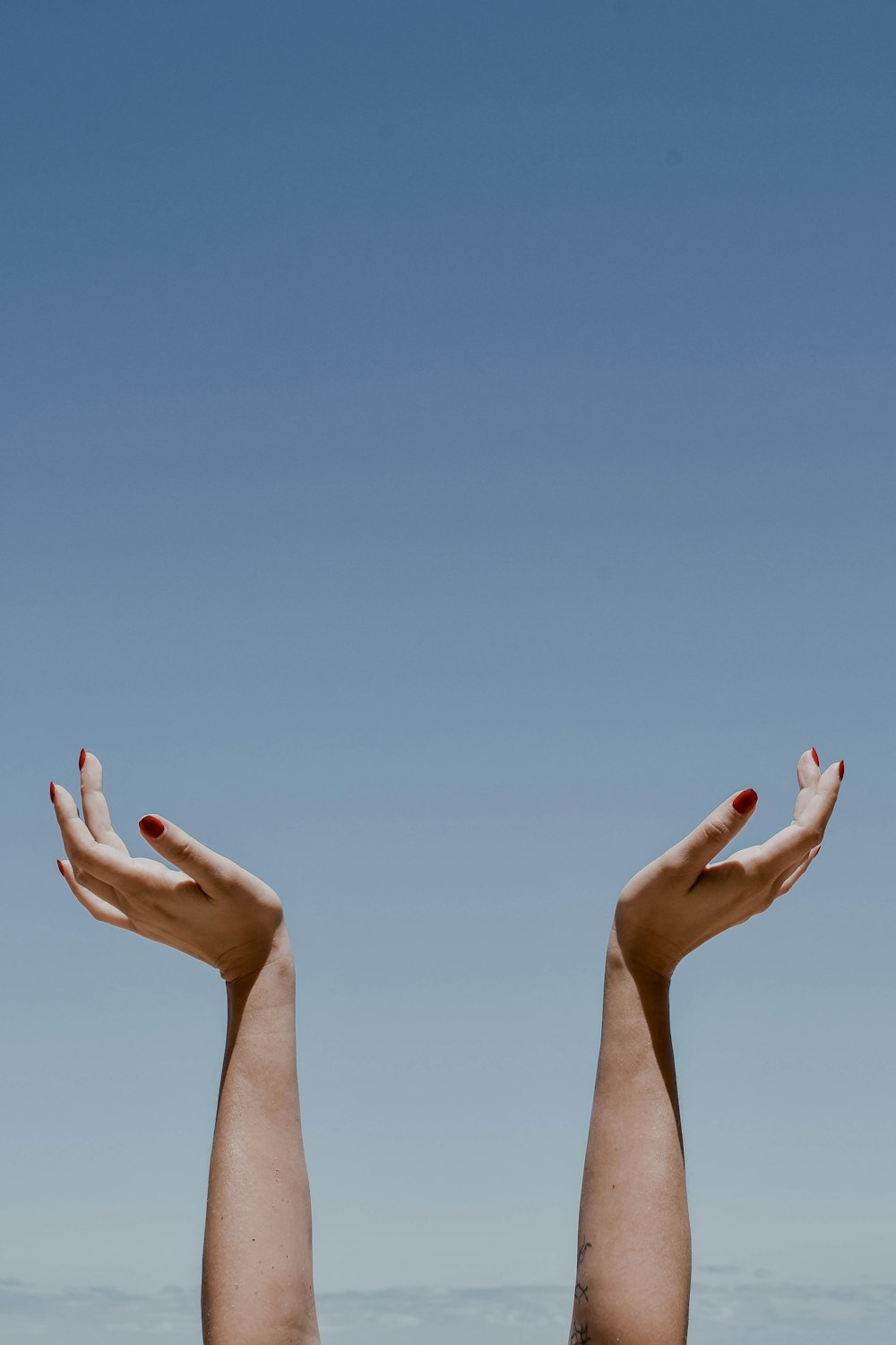 a woman's legs are stretched out on the beach