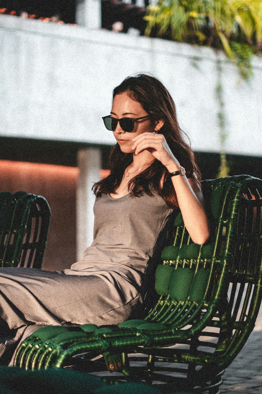 a woman sitting in a chair with her legs crossed