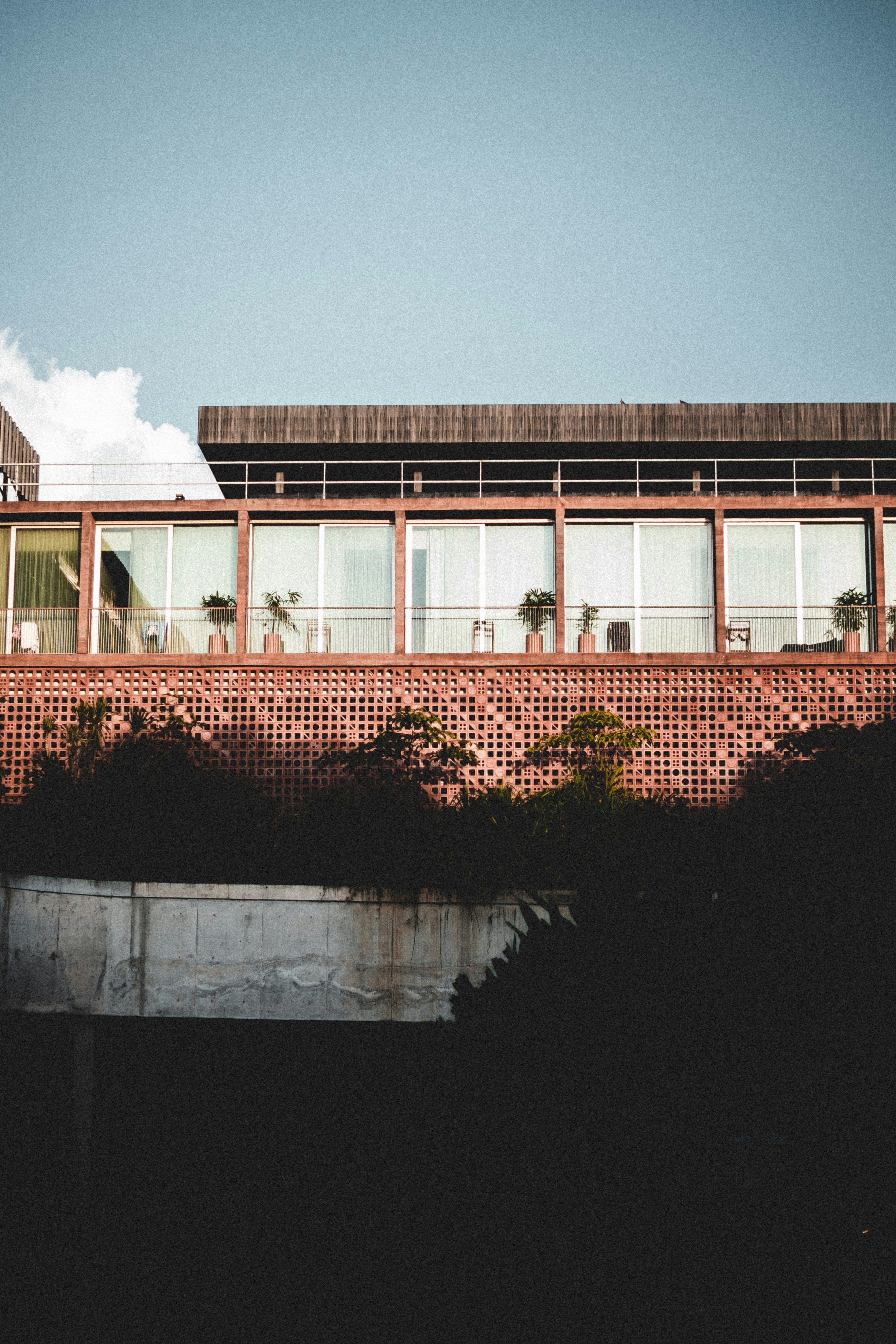 a red brick building with palm trees in front of it