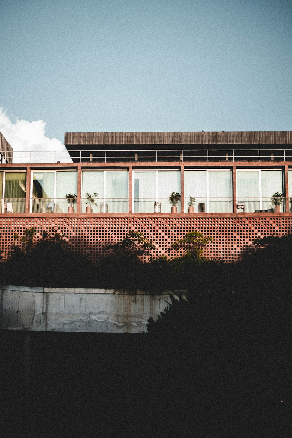 a red brick building with palm trees in front of it