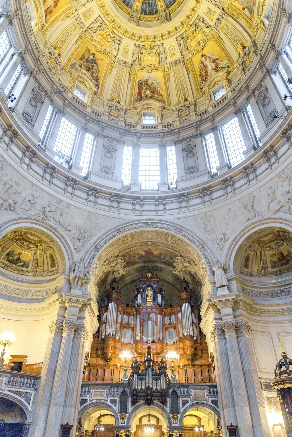 a large cathedral with a dome ceiling and stained glass windows