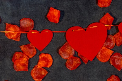 A romantic collage featuring couples' pictures intertwined with heart-shaped designs.