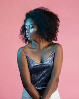 Portrait of a confident woman with shiny, voluminous hair expressing self-care and presence.