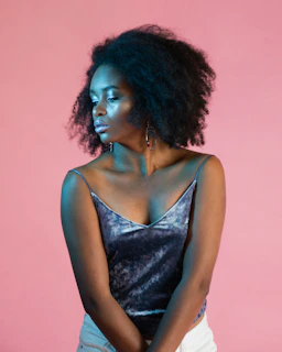 Portrait of a confident woman with shiny, voluminous hair expressing self-care and presence.