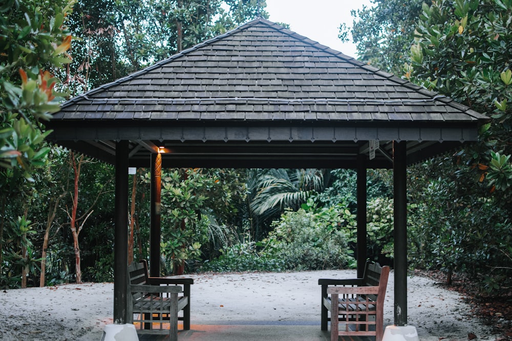 a gazebo in the middle of a wooded area