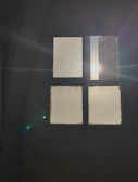Close-up of a sleek glass window reinforced with a clear safety film, sunlight softly filtering through.