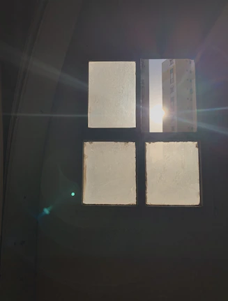 Close-up of a sleek glass window reinforced with a clear safety film, sunlight softly filtering through.