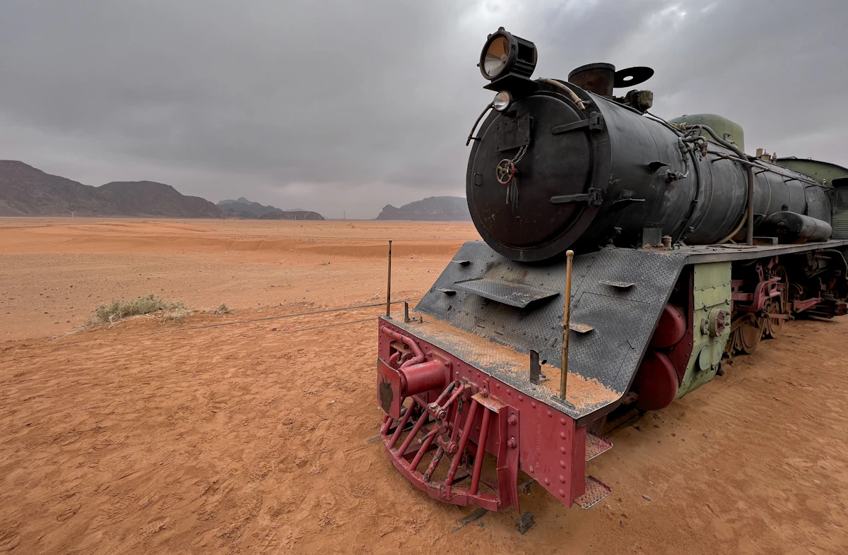 A passenger train crossing an open desert landscape
