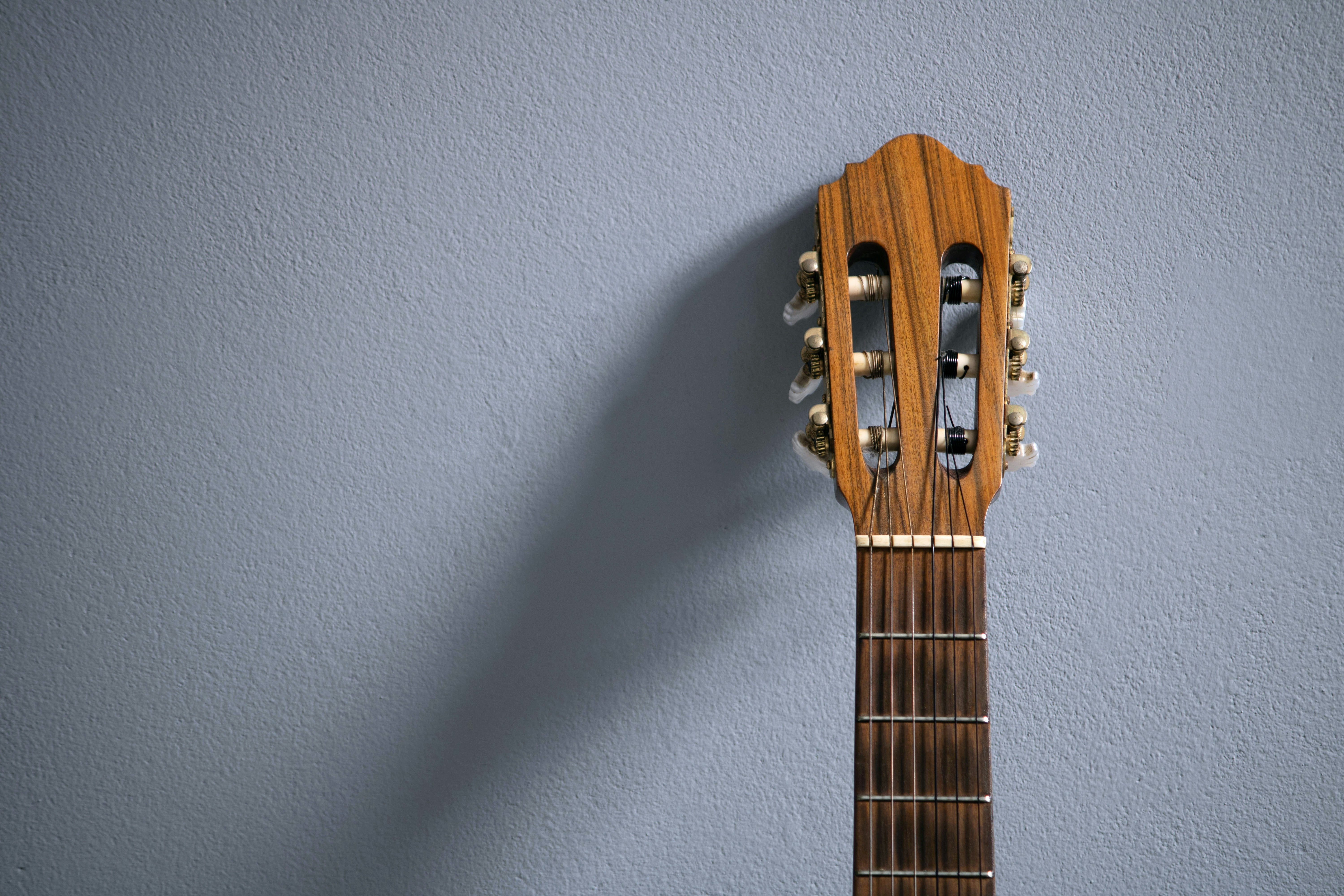 a ukulele hanging on a blue wall