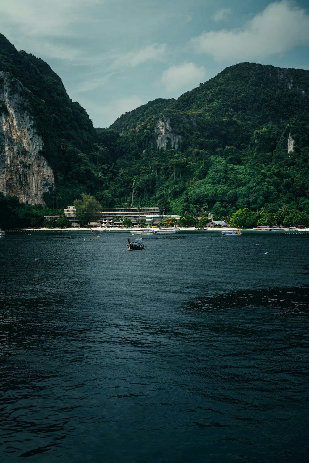 a boat in a body of water with mountains in the background