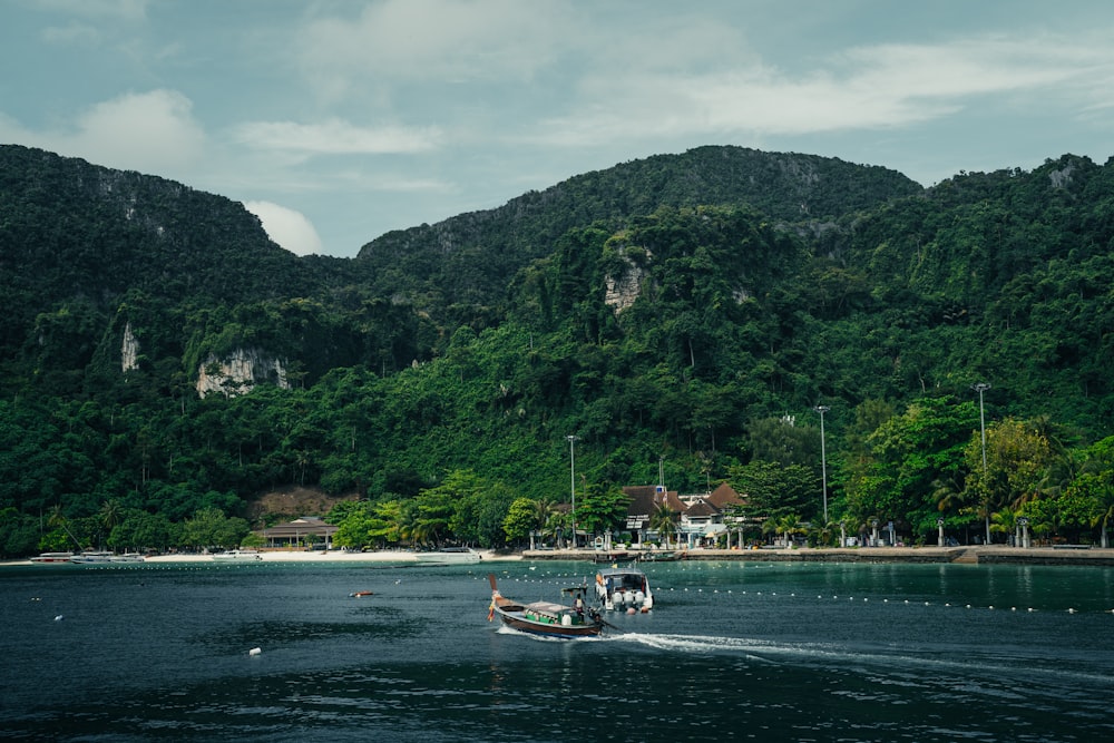 a boat is traveling on a body of water