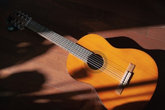 a close up of a guitar on a wooden floor