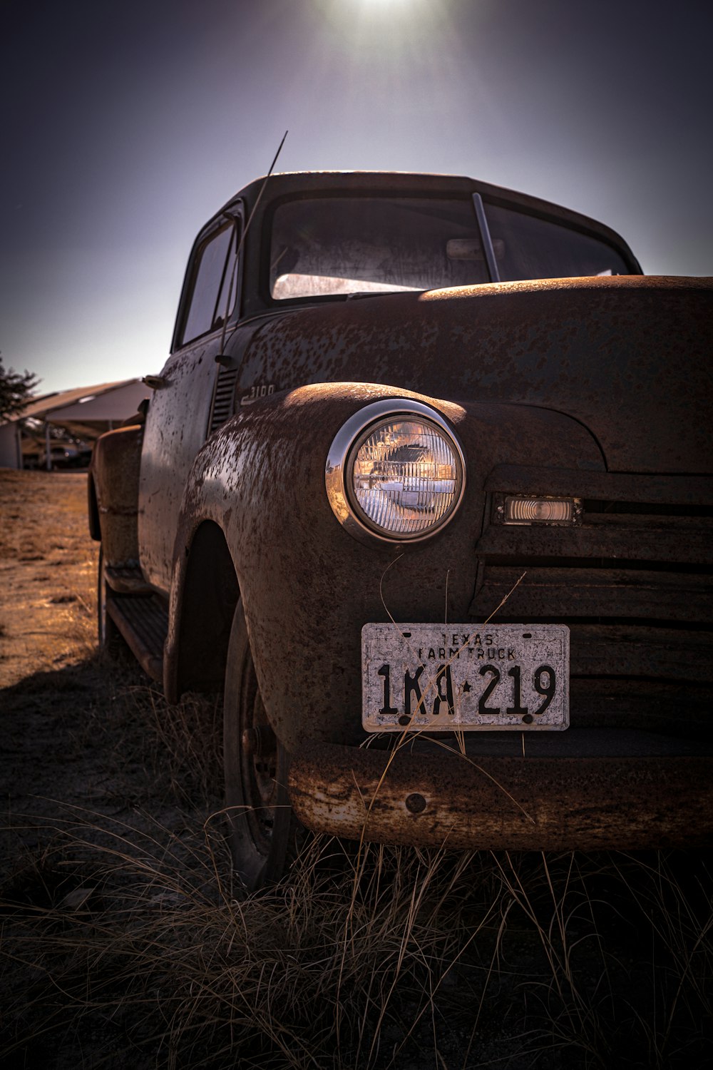 an old car is parked in a field