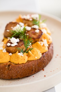 Close-up of zok pickle spread on fresh bread with bright, colorful vegetables around