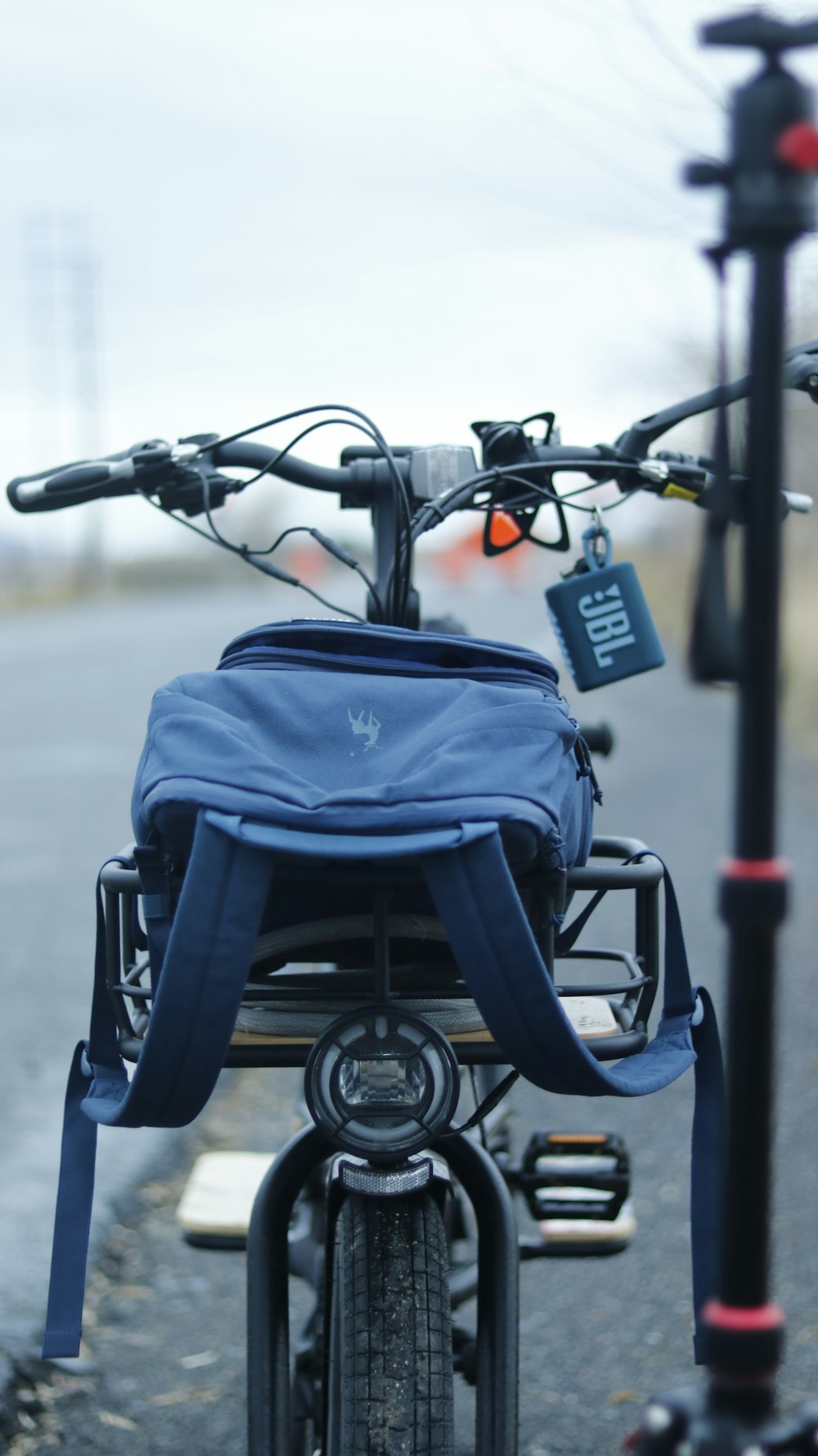 a bicycle with a blue bag on the back of it