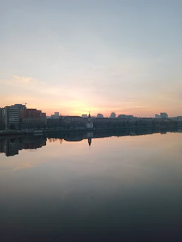 A calm cityscape with a sunrise symbolizing protection and new beginnings.