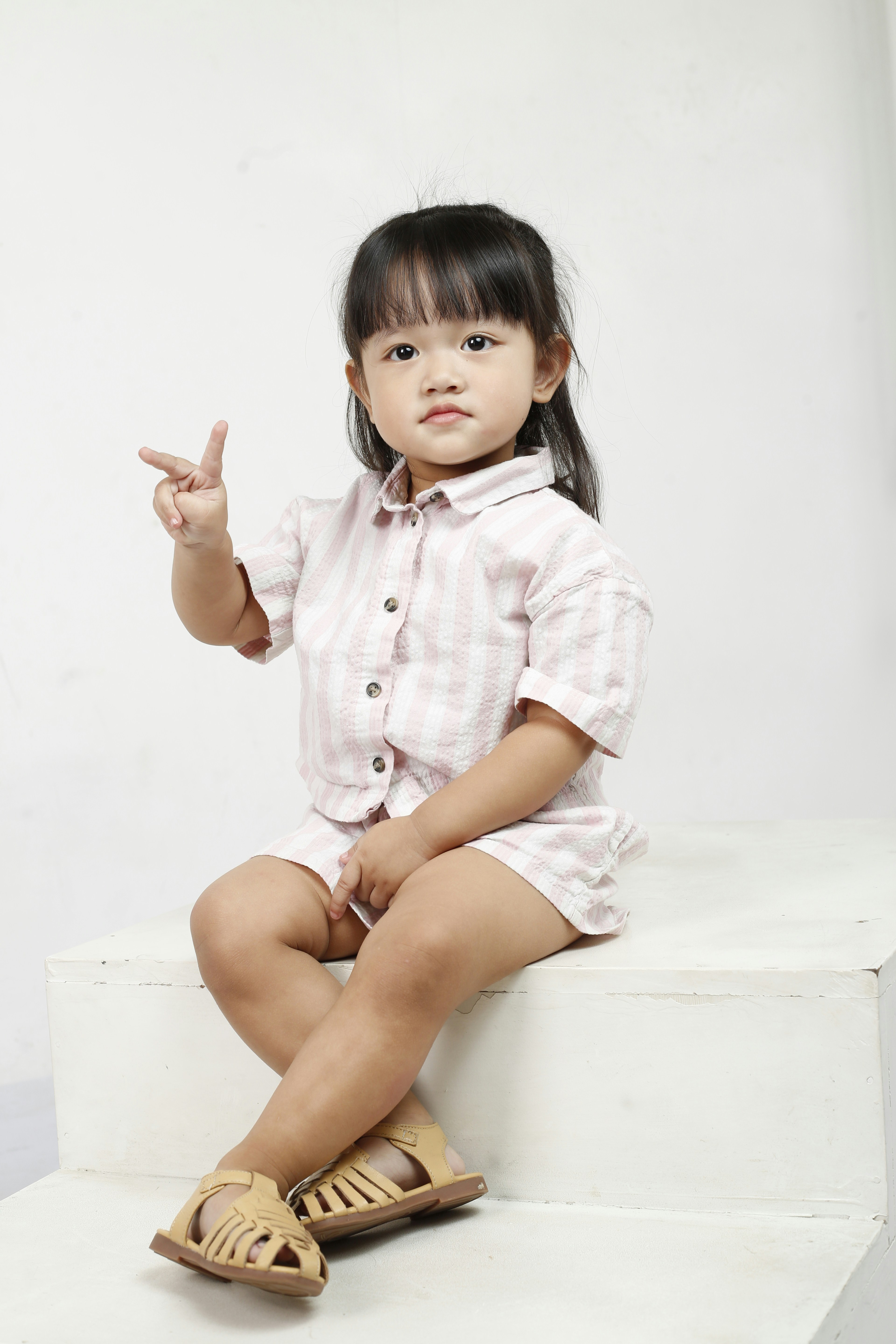 A child psychologist interacting with a young student in a bright, friendly classroom environment.