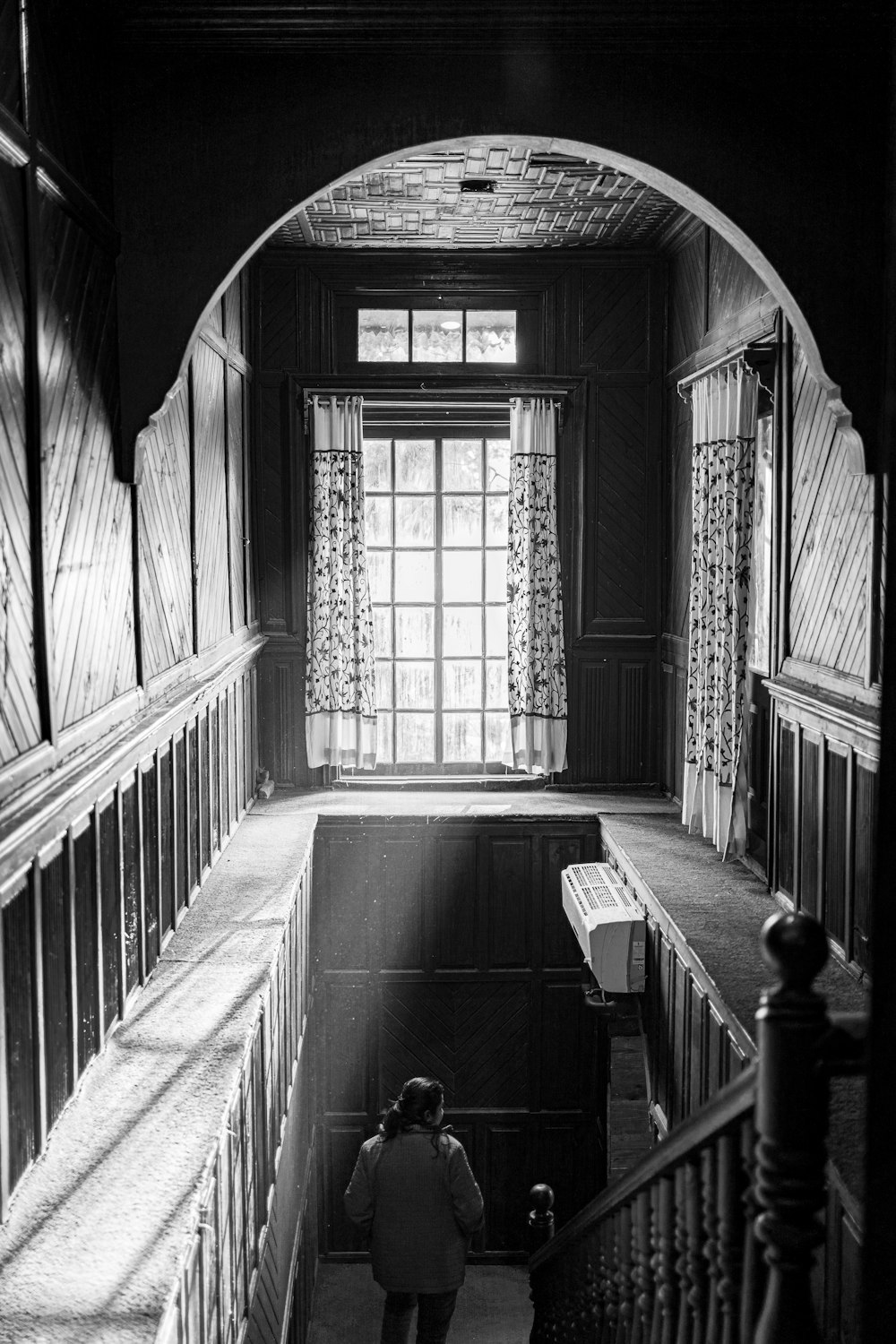 a black and white photo of a person standing in a room