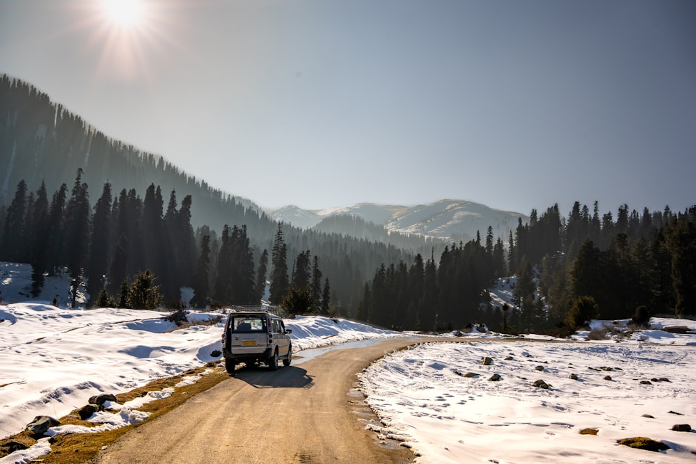 a van driving down a snow covered road