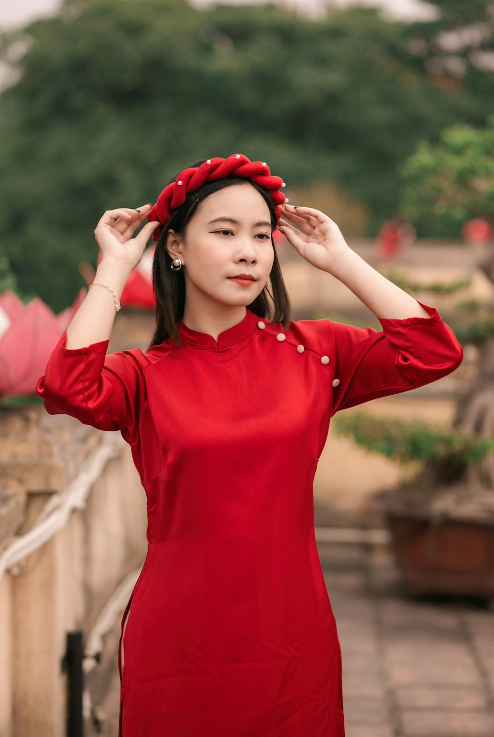 a woman in a red dress is holding her head