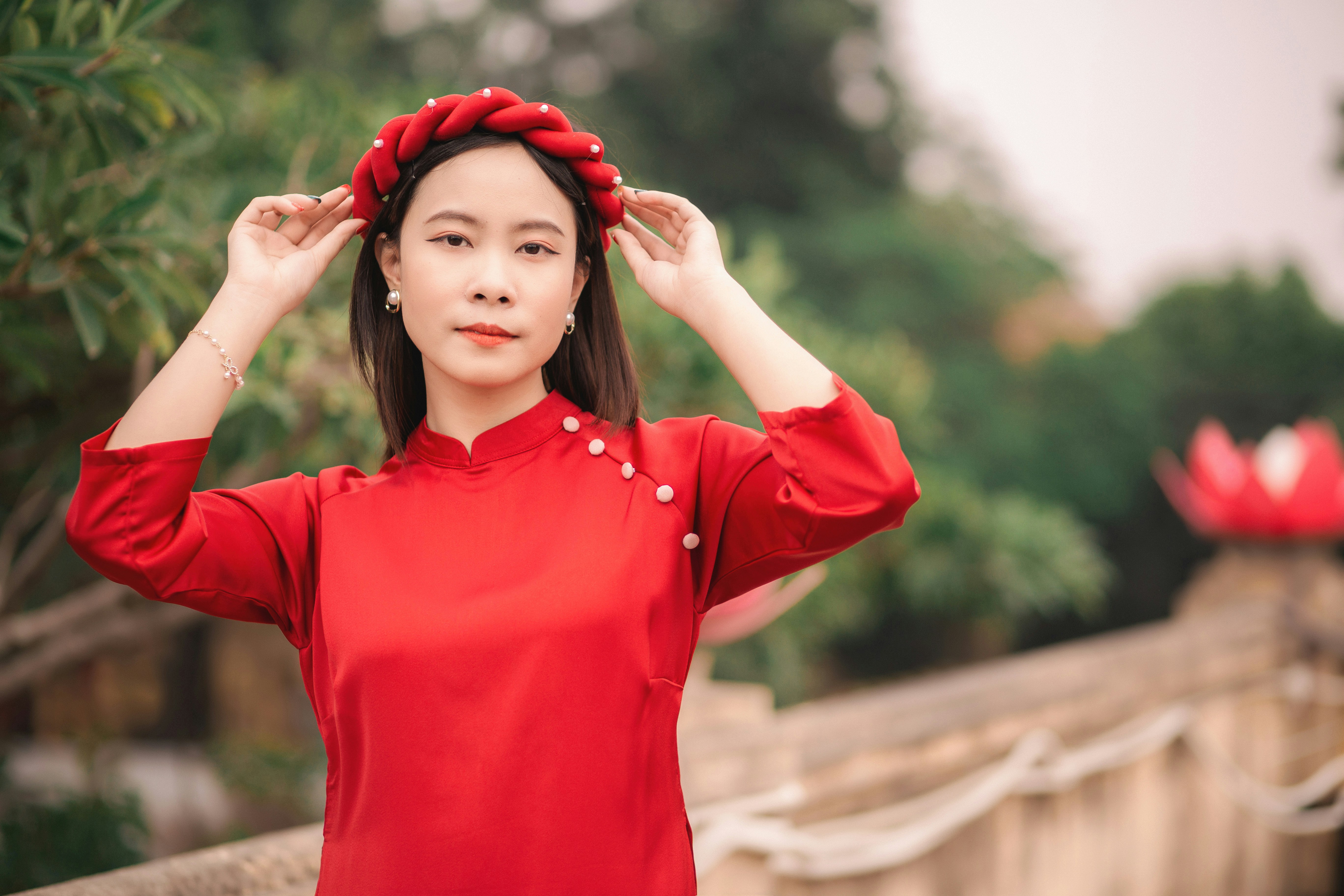a woman in a red dress is holding her head