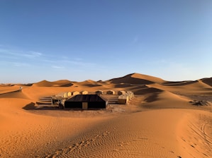 a hut in the middle of the desert