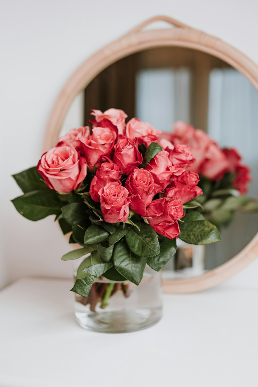 a vase filled with red flowers on top of a table