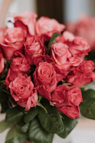 a bouquet of red roses sitting on a table